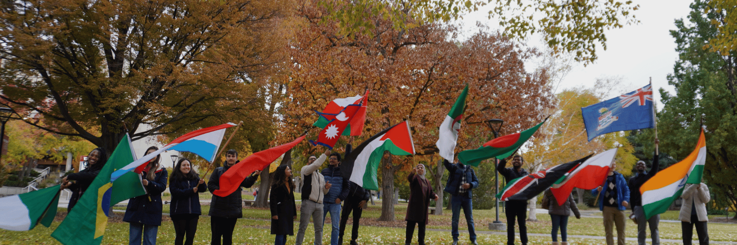 International students waving flags from their home countries.